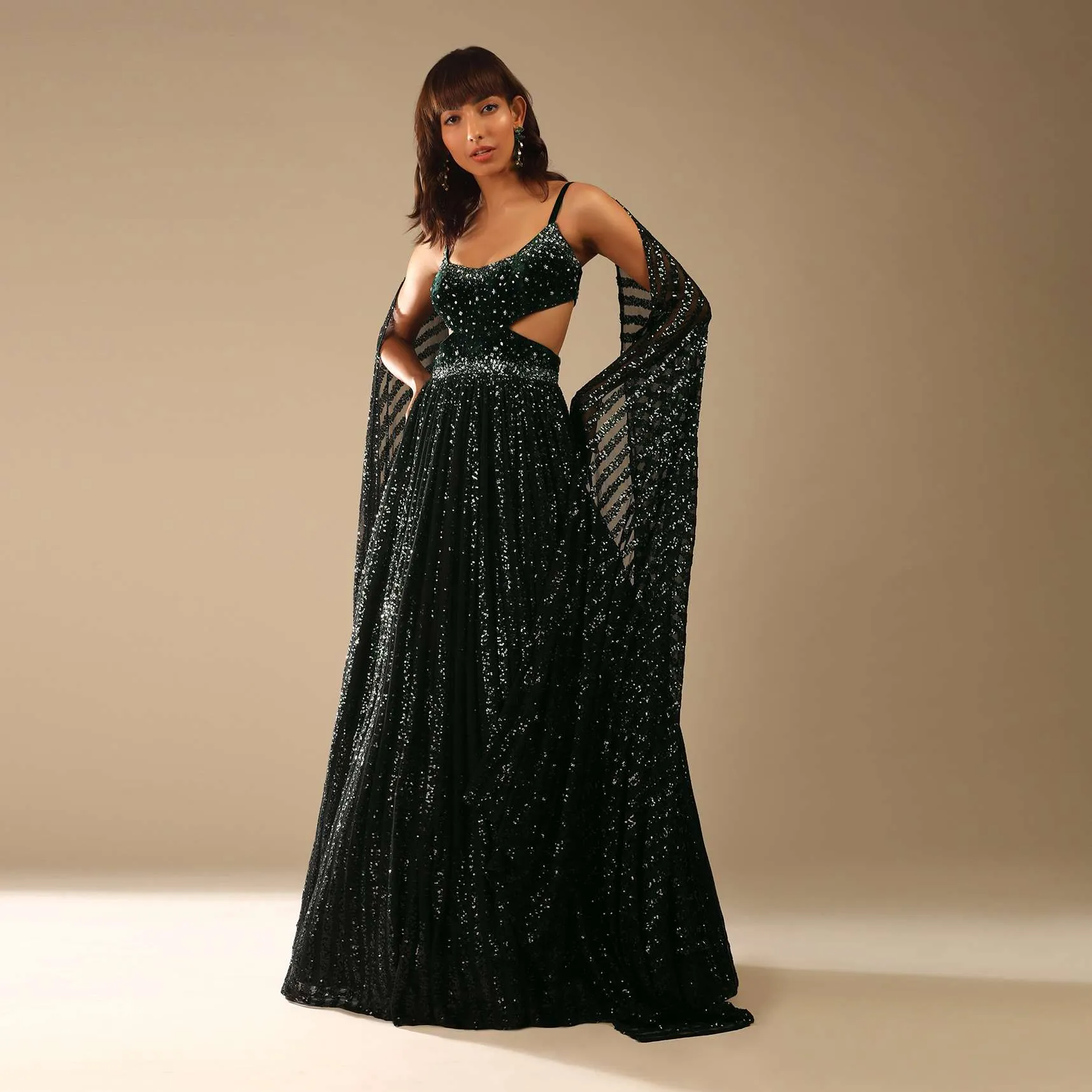Dark Green Gown Embellished In Sequins With A Velvet Bodice Adorned In Hand Embroidery And Cape On The Shoulder Online - Kalki Fashion